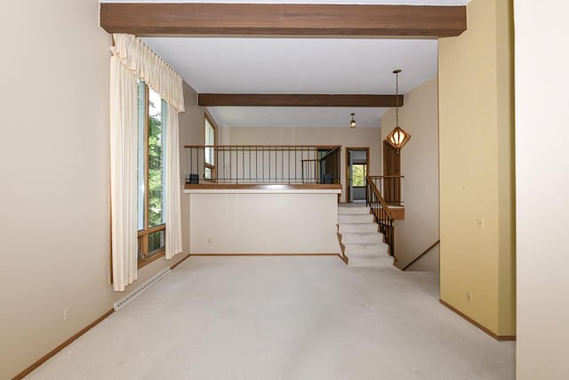 12929 N Colony Dr, Mequon, WI 53097 - spare room with a baseboard radiator, beam ceiling, and carpet
