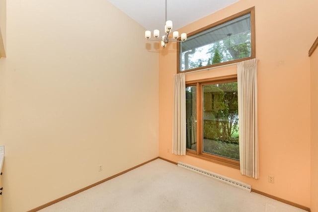 12929 N Colony Dr, Mequon, WI 53097 - carpeted empty room with baseboard heating and a chandelier