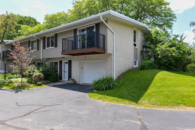12929 N Colony Dr, Mequon, WI 53097 - multi unit property with brick siding, a balcony, an attached garage, a front yard, and asphalt driveway