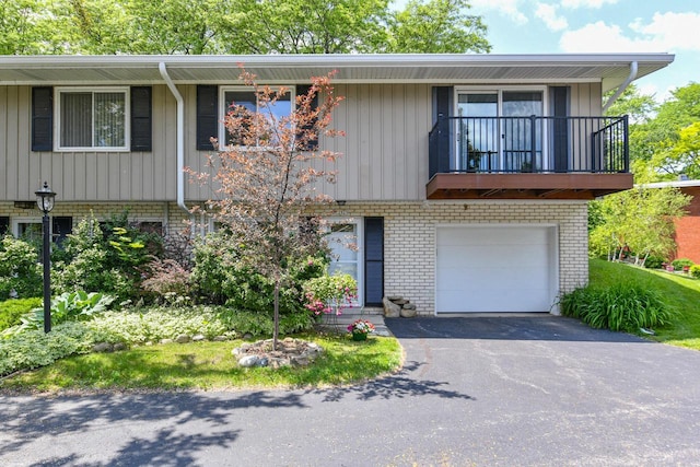 12929 N Colony Dr, Mequon, WI 53097 - multi unit property with brick siding, asphalt driveway, a balcony, and a garage