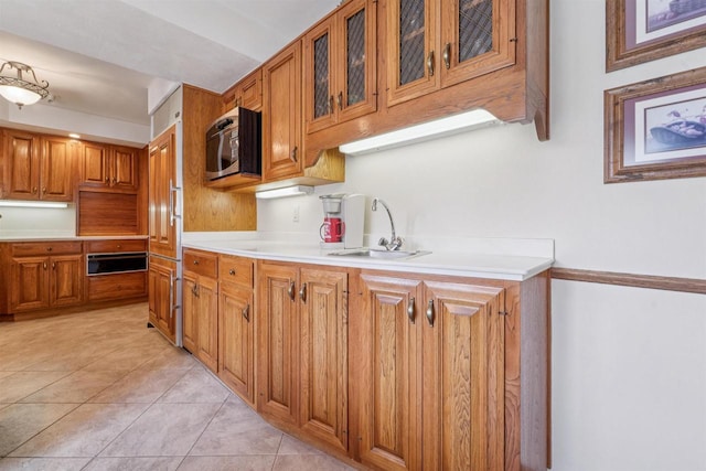 2213 Sunrise Dr, Appleton, WI 54914 - kitchen with stainless steel microwave, a warming drawer, brown cabinets, and light countertops