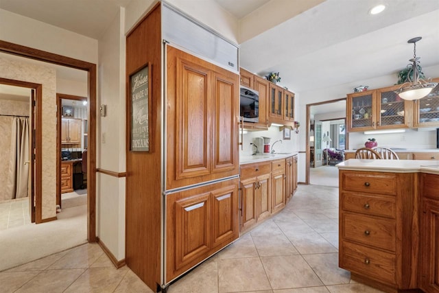 2213 Sunrise Dr, Appleton, WI 54914 - kitchen featuring brown cabinetry, glass insert cabinets, light tile patterned floors, and light countertops