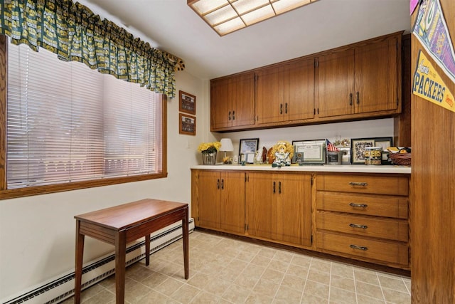 2213 Sunrise Dr, Appleton, WI 54914 - kitchen with baseboard heating, light countertops, and brown cabinetry