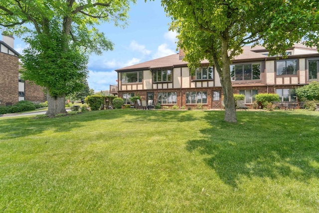 2213 Sunrise Dr, Appleton, WI 54914 - rear view of house featuring a yard and brick siding