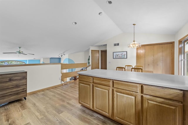 15 Naylor Cir, Madison, WI 53719 - kitchen with a ceiling fan, light wood-style floors, lofted ceiling, pendant lighting, and light countertops