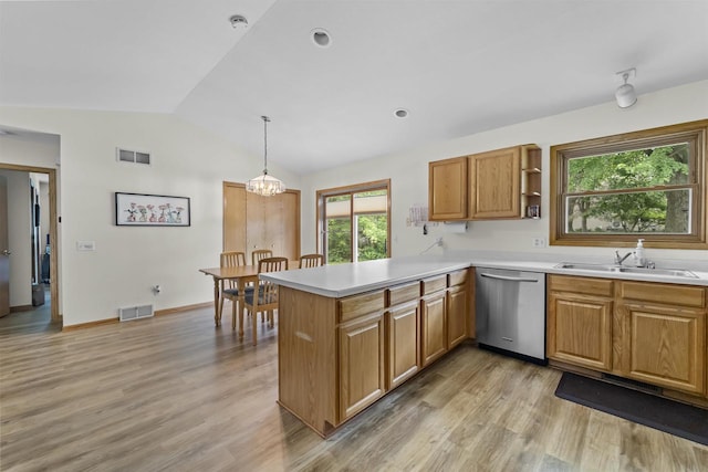 15 Naylor Cir, Madison, WI 53719 - kitchen with stainless steel dishwasher, vaulted ceiling, light wood-style floors, a peninsula, and light countertops