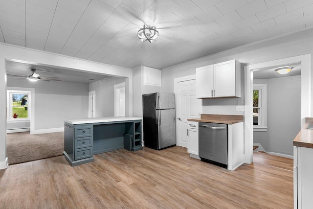 206 W Willow St, Bear Creek, WI 54922 - kitchen with appliances with stainless steel finishes, baseboard heating, butcher block counters, white cabinetry, and light wood-style flooring