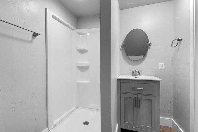 206 W Willow St, Bear Creek, WI 54922 - bathroom with vanity, a shower, and wood finished floors