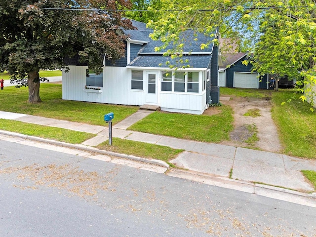 206 W Willow St, Bear Creek, WI 54922 - view of front of house with dirt driveway, roof with shingles, a front yard, and a garage