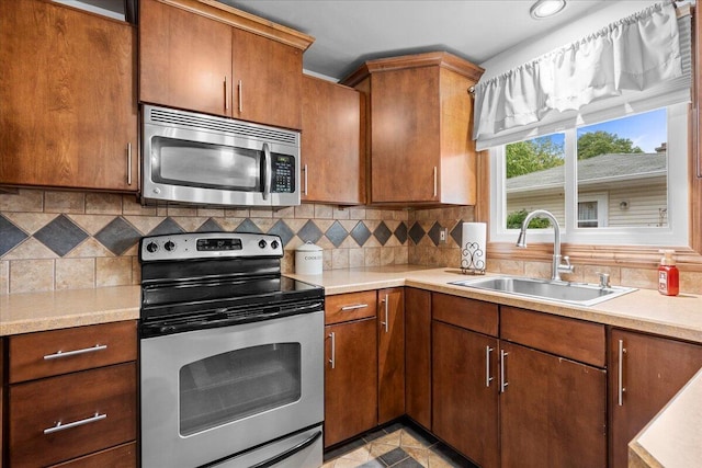 1918 Wilson Ave, Sheboygan, WI 53081 - kitchen featuring appliances with stainless steel finishes, light countertops, and backsplash