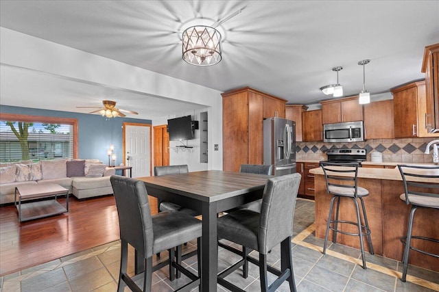 1918 Wilson Ave, Sheboygan, WI 53081 - dining space featuring ceiling fan and a chandelier