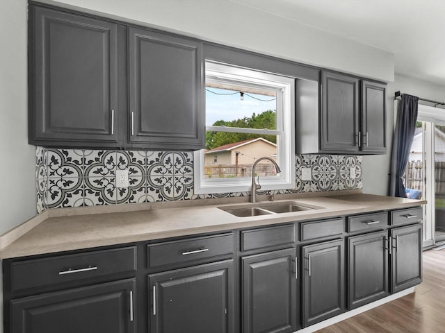 328 W Wilson St, Valders, WI 54245 - kitchen with tasteful backsplash, wood finished floors, and light countertops