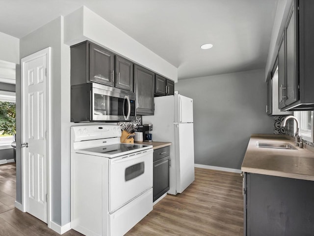328 W Wilson St, Valders, WI 54245 - kitchen featuring white appliances, wood finished floors, recessed lighting, and light countertops