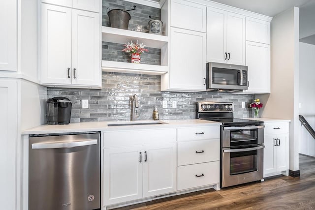 5090 N Milkweed Trl, Appleton, WI 54913 - kitchen featuring appliances with stainless steel finishes, light countertops, white cabinetry, and dark wood finished floors
