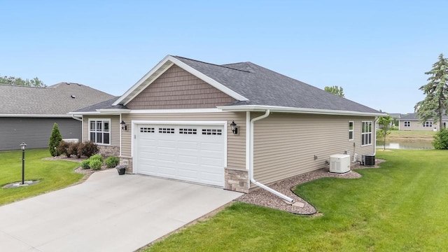 5090 N Milkweed Trl, Appleton, WI 54913 - view of side of property featuring a garage, concrete driveway, a yard, and a water view