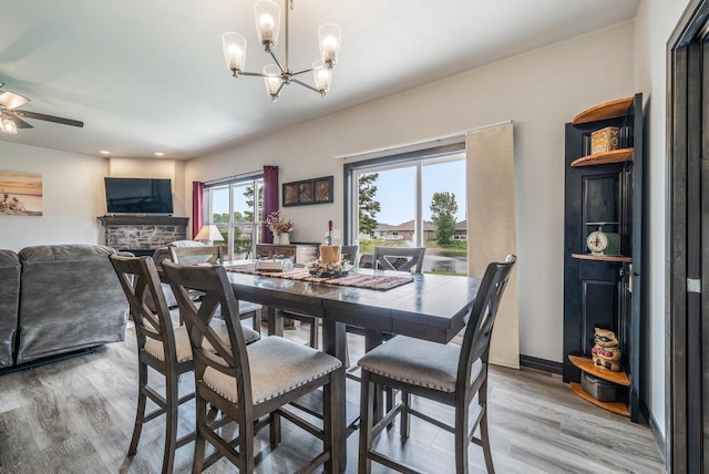 5090 N Milkweed Trl, Appleton, WI 54913 - dining space featuring a chandelier, light wood finished floors, a ceiling fan, a fireplace, and recessed lighting