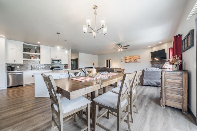 5090 N Milkweed Trl, Appleton, WI 54913 - dining space featuring a ceiling fan, light wood-style floors, a chandelier, and recessed lighting