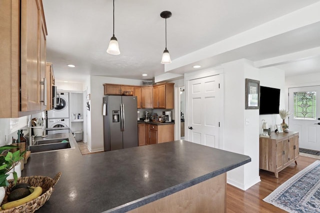 228 N Pleasant Ave, Jefferson, WI 53549 - kitchen with stainless steel refrigerator with ice dispenser, stacked washer / dryer, a peninsula, dark countertops, and recessed lighting