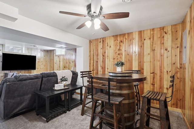 228 N Pleasant Ave, Jefferson, WI 53549 - bar featuring wood walls, carpet floors, and a ceiling fan