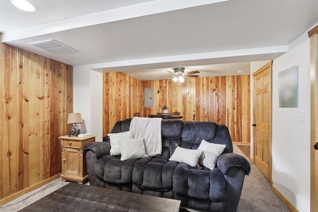 228 N Pleasant Ave, Jefferson, WI 53549 - living room featuring wood walls, carpet, and a ceiling fan