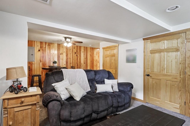 228 N Pleasant Ave, Jefferson, WI 53549 - living area with wood walls, dark carpet, ceiling fan, and electric panel