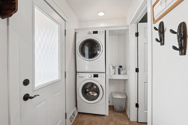 228 N Pleasant Ave, Jefferson, WI 53549 - laundry area with stacked washer and clothes dryer and tile patterned flooring