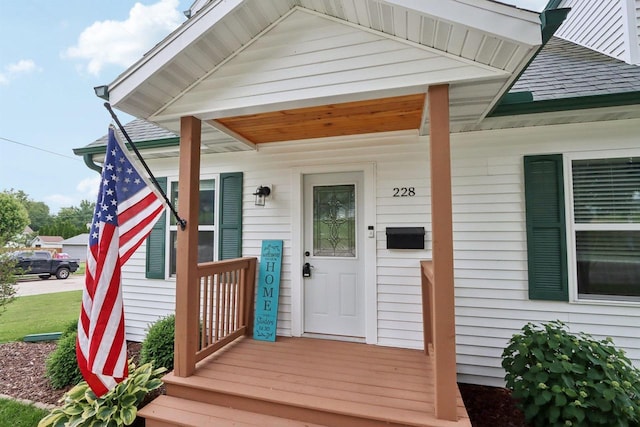 228 N Pleasant Ave, Jefferson, WI 53549 - property entrance featuring a shingled roof and a porch