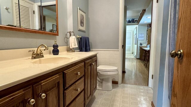 3218 N 13th St, Wausau, WI 54403 - bathroom featuring wainscoting, tile patterned floors, vanity, and tile walls