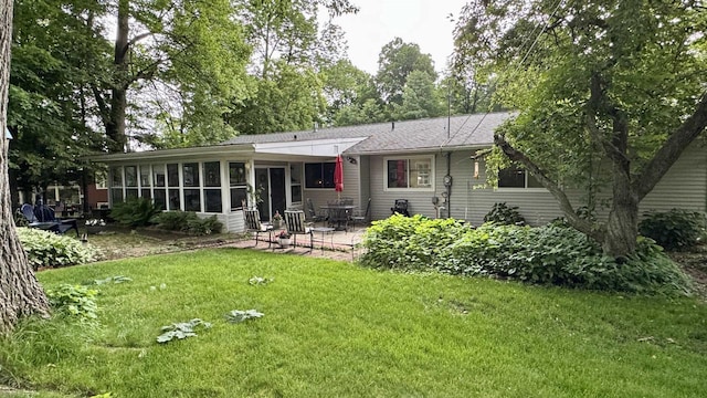 3218 N 13th St, Wausau, WI 54403 - rear view of house with a patio area, a sunroom, a yard, and roof with shingles