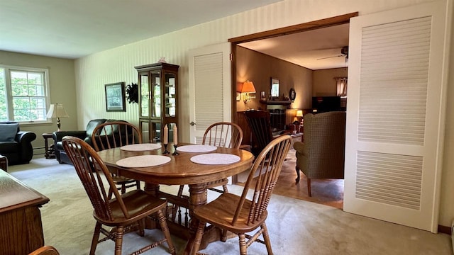 3218 N 13th St, Wausau, WI 54403 - dining area featuring light carpet, ceiling fan, and baseboard heating