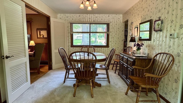 3218 N 13th St, Wausau, WI 54403 - dining room with wallpapered walls, light colored carpet, and a chandelier