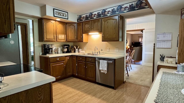3218 N 13th St, Wausau, WI 54403 - kitchen with dishwasher, light wood finished floors, light countertops, and freestanding refrigerator