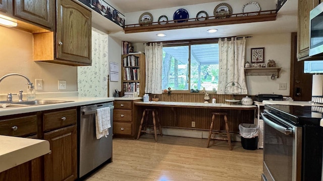 3218 N 13th St, Wausau, WI 54403 - kitchen featuring appliances with stainless steel finishes, light wood finished floors, and light countertops