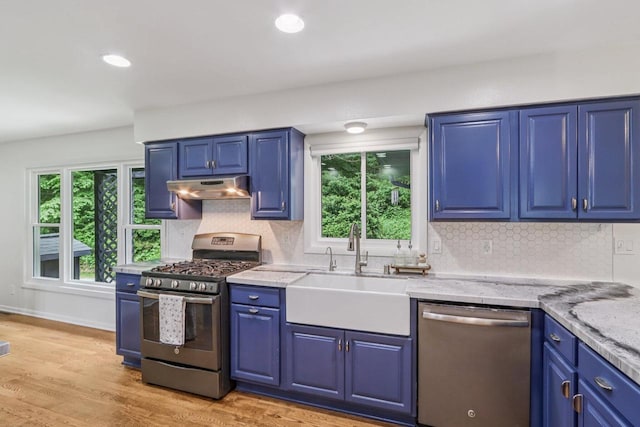 S83W27815 Beaver Trl, Mukwonago, WI 53149 - kitchen with appliances with stainless steel finishes, under cabinet range hood, blue cabinets, tasteful backsplash, and recessed lighting