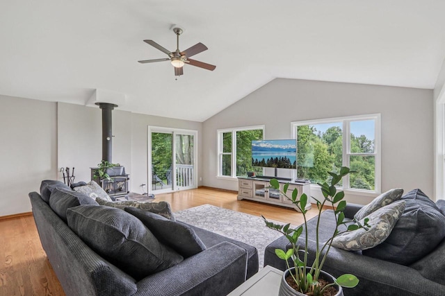 S83W27815 Beaver Trl, Mukwonago, WI 53149 - living area featuring a wood stove, ceiling fan, plenty of natural light, lofted ceiling, and light wood-style floors