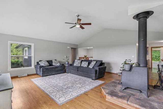 S83W27815 Beaver Trl, Mukwonago, WI 53149 - living room featuring a wood stove, a ceiling fan, wood finished floors, and high vaulted ceiling