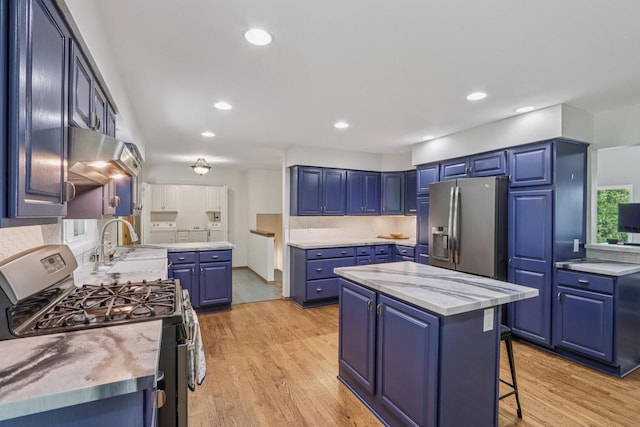 S83W27815 Beaver Trl, Mukwonago, WI 53149 - kitchen with stainless steel appliances, blue cabinetry, light wood-style floors, a center island, and recessed lighting