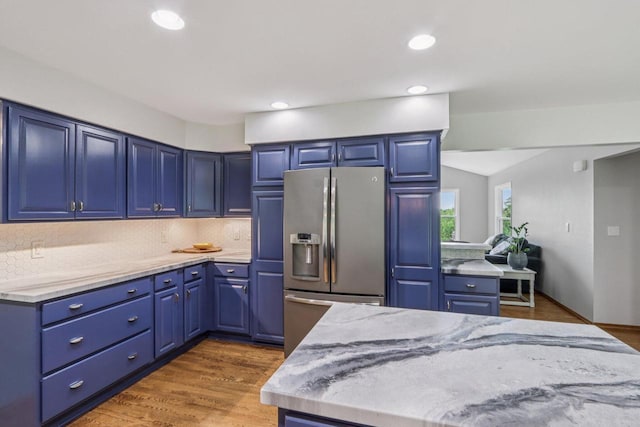 S83W27815 Beaver Trl, Mukwonago, WI 53149 - kitchen with stainless steel refrigerator with ice dispenser, decorative backsplash, light stone counters, recessed lighting, and wood finished floors