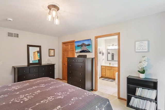 3176 Weybridge Dr, Sun Prairie, WI 53590 - bedroom with connected bathroom and light tile patterned floors