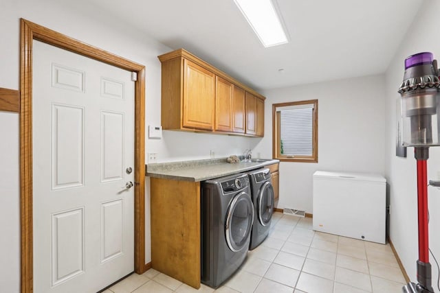 3176 Weybridge Dr, Sun Prairie, WI 53590 - washroom with cabinet space, washer and dryer, and light tile patterned floors