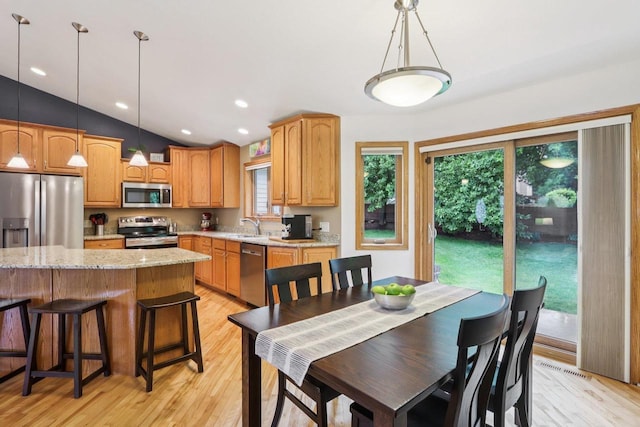 3176 Weybridge Dr, Sun Prairie, WI 53590 - dining area featuring light wood-type flooring, lofted ceiling, and recessed lighting