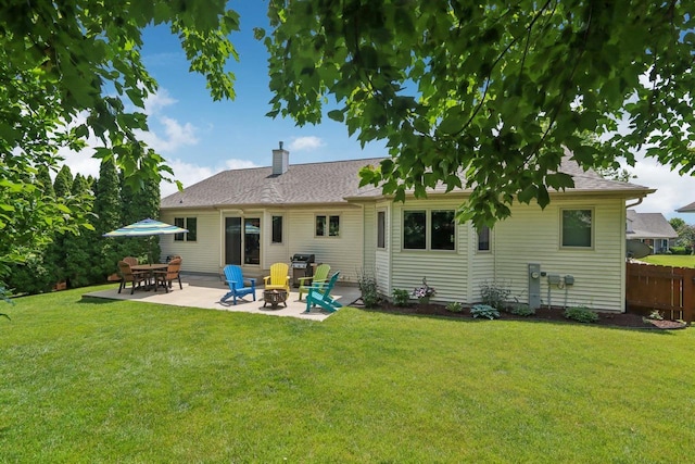 3176 Weybridge Dr, Sun Prairie, WI 53590 - back of property featuring a patio, a chimney, an outdoor fire pit, and a shingled roof