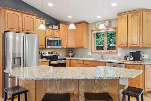 3176 Weybridge Dr, Sun Prairie, WI 53590 - kitchen featuring stainless steel appliances, light stone countertops, a breakfast bar, vaulted ceiling, and recessed lighting