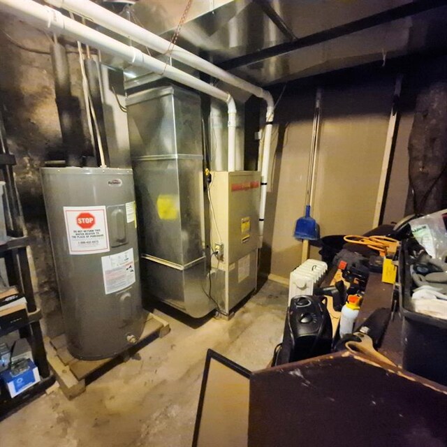 15531 Lakewood Dr, Hayward, WI 54843 - utility room with electric water heater and heating unit