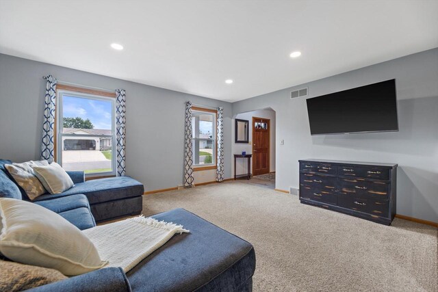 W163N10515 Ridgeview Ln, Germantown, WI 53022 - living area with healthy amount of natural light, recessed lighting, carpet, and arched walkways