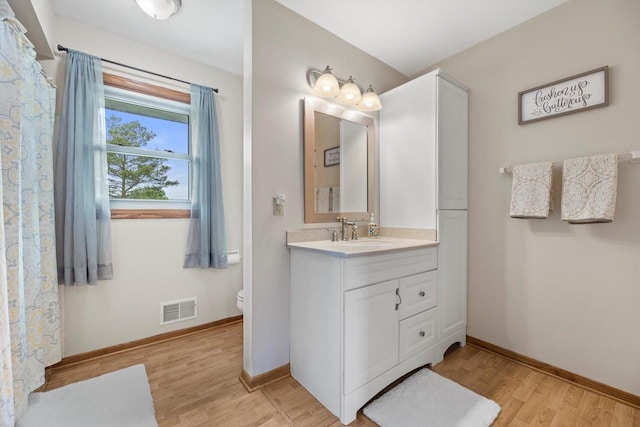 W163N10515 Ridgeview Ln, Germantown, WI 53022 - full bathroom with vanity and wood finished floors