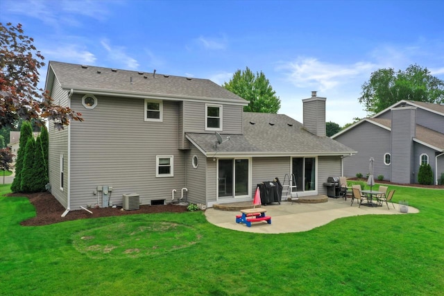 W163N10515 Ridgeview Ln, Germantown, WI 53022 - back of house featuring a patio, a yard, a chimney, and roof with shingles