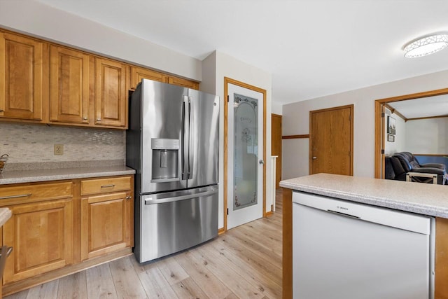 W163N10515 Ridgeview Ln, Germantown, WI 53022 - kitchen with white dishwasher, stainless steel refrigerator with ice dispenser, light wood-style floors, and light countertops
