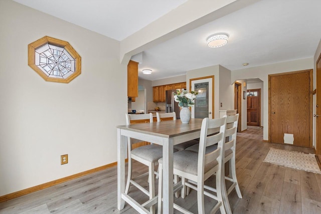 W163N10515 Ridgeview Ln, Germantown, WI 53022 - dining room with arched walkways and light wood-style floors