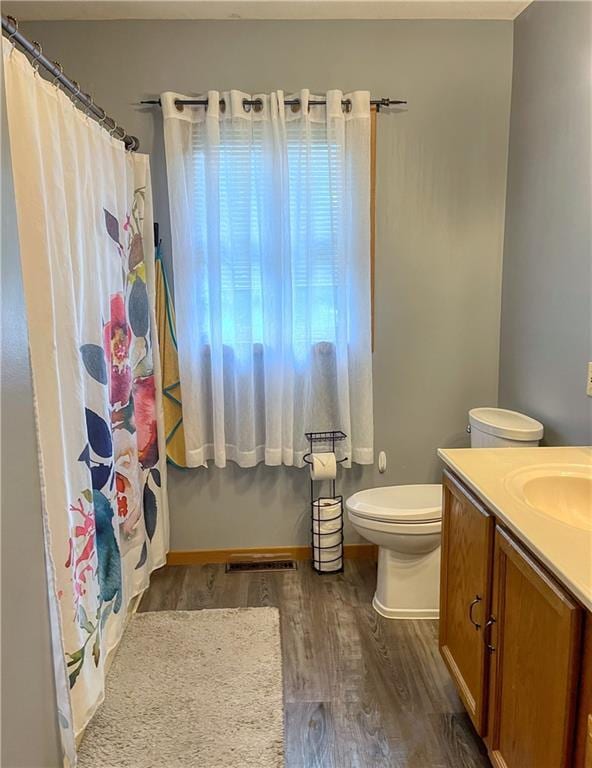 608 3rd St, Cameron, WI 54822 - bathroom featuring wood finished floors, vanity, and a shower with curtain